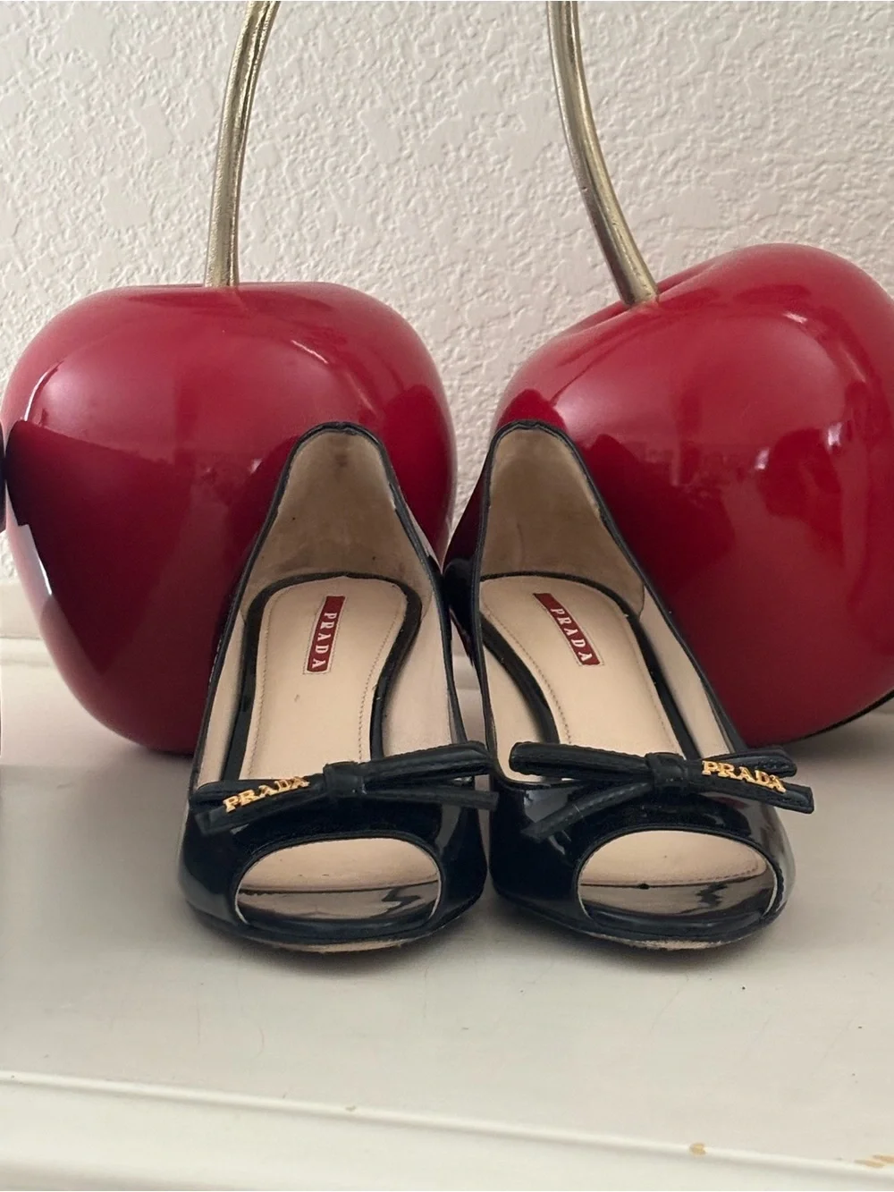 Prada Black Patent Leather Peep-Toe Wedges with Bow and Gold Accent